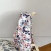 BS-ACC-023_2 White Butterfly Print Backpack with Plush Charm