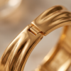 Sculptural Wrap Cuff Bracelet — Gold-Tone Stainless Steel, Hinged Opening