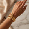 Sculptural Wrap Cuff Bracelet — Gold-Tone Stainless Steel, Hinged Opening